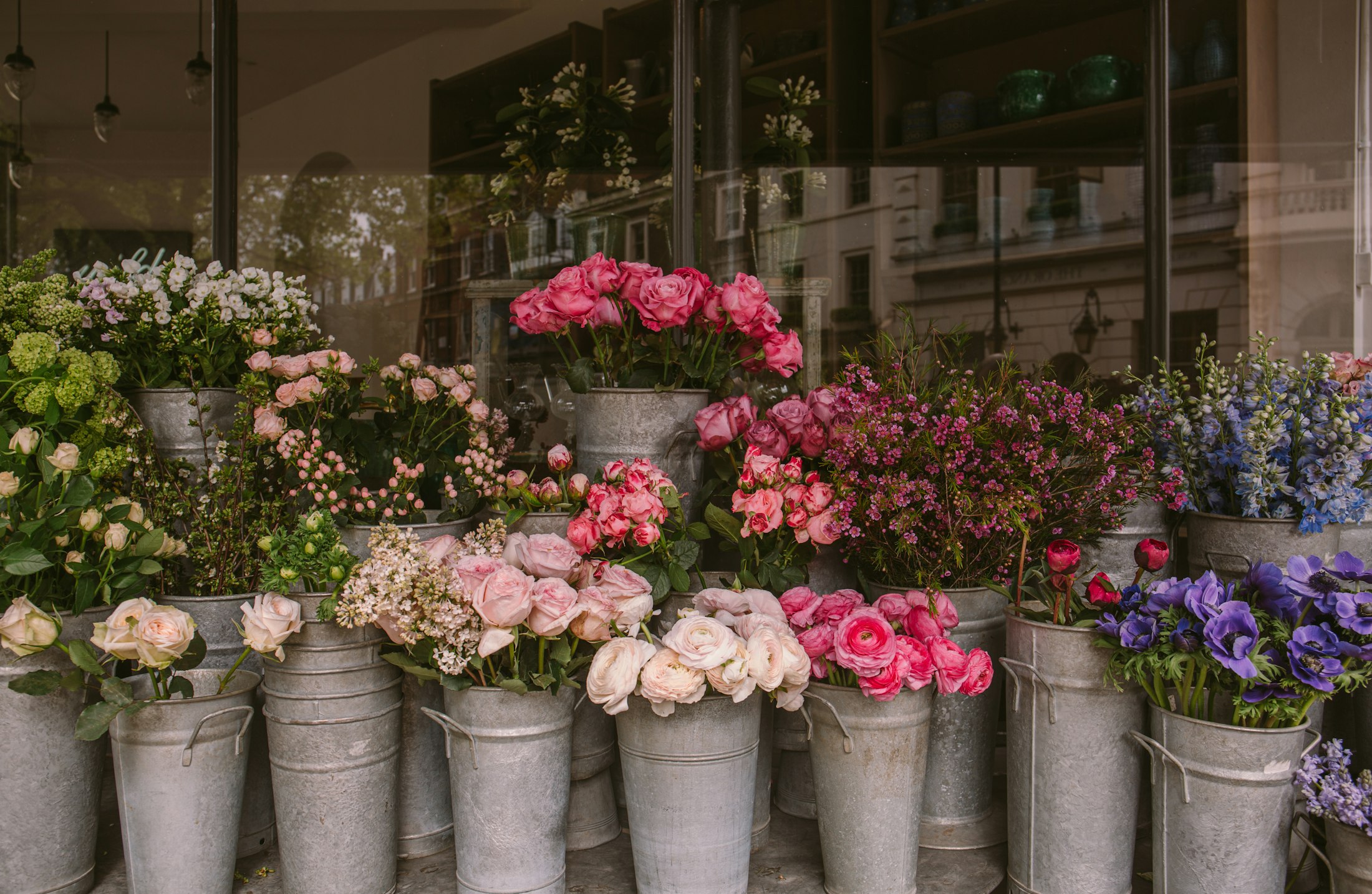 Buckets of fresh roses, peonies and seasonal flowers